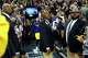 After passing the ball, Oracle Arena security guard Curtis Jones watches its flight as Warriors guard Stephen Curry does his tunnel shot ritual in Oakland on April 2, 2019.