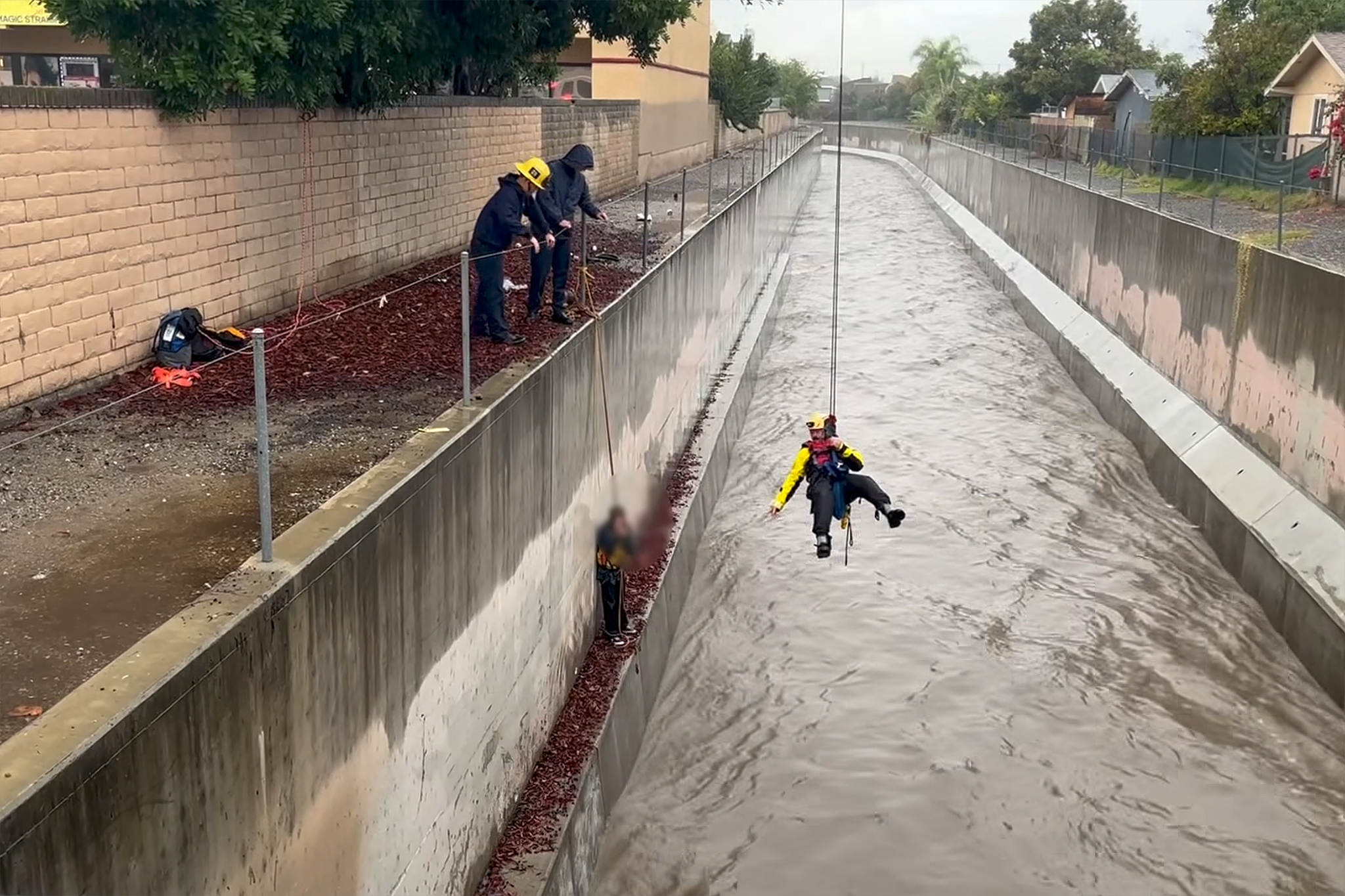Man swept over a mile in raging floodwaters as storms batter California