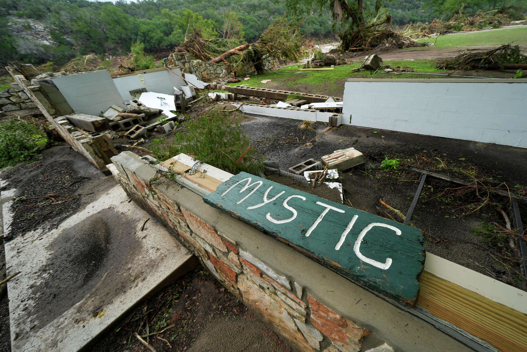 A Camp Mystic sign is seen near the entrance to the establishment along the banks of the Guadalupe River in Hunt, Texas, Saturday, July 5, 2025, after a flash flood swept through the area. (AP Photo/Julio Cortez)