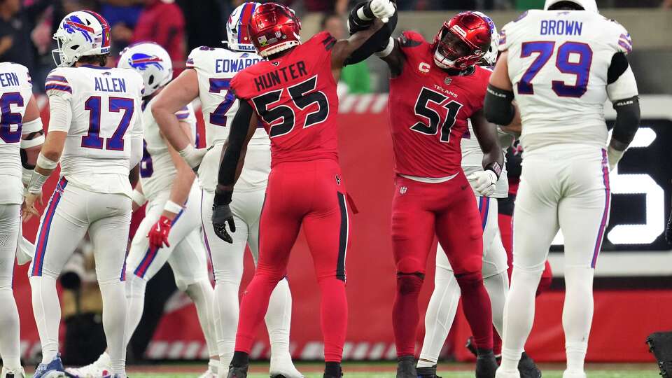 Houston Texans defensive end Will Anderson Jr. (51) celebrates with defensive end Danielle Hunter (55) after Buffalo Bills quarterback Josh Allen was sacked during the second half of an NFL football game in Houston, Thursday, Nov. 20, 2025.