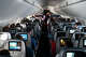 Flight attendants hand out refreshments to a packed Delta Air Lines flight traveling from Ronald Reagan Washington National Airport to Minneapolis Saint Paul International Airport on Friday, May 21, 2021.