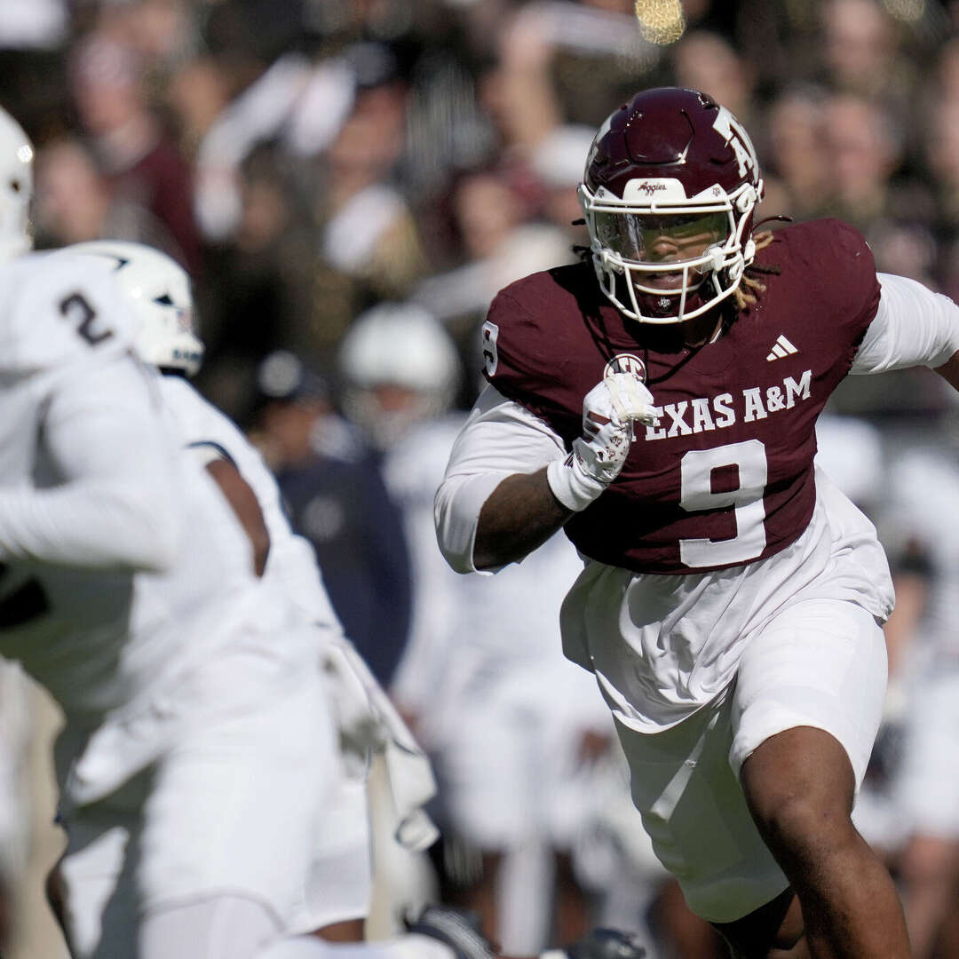 Texas A&M defensive end Cashius Howell (9) rushes Samford quarterback Quincy Crittendon (2) during the first quarter Nov. 22, 2025, in College Station.