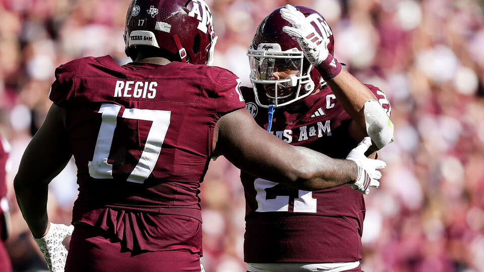 Texas A&M linebacker Taurean York (21) and defensive lineman and Albert Regis react against the South Carolina Gamecocks during the fourth quarter at Kyle Field on Nov. 15, 2025 in College Station. 