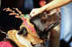 A person pets a dog that has moose antlers on its head during a Canine Fashion Show with Christmas Costumes in Cuscatlan Park on Nov. 23, 2025 in San Salvador, El Salvador.