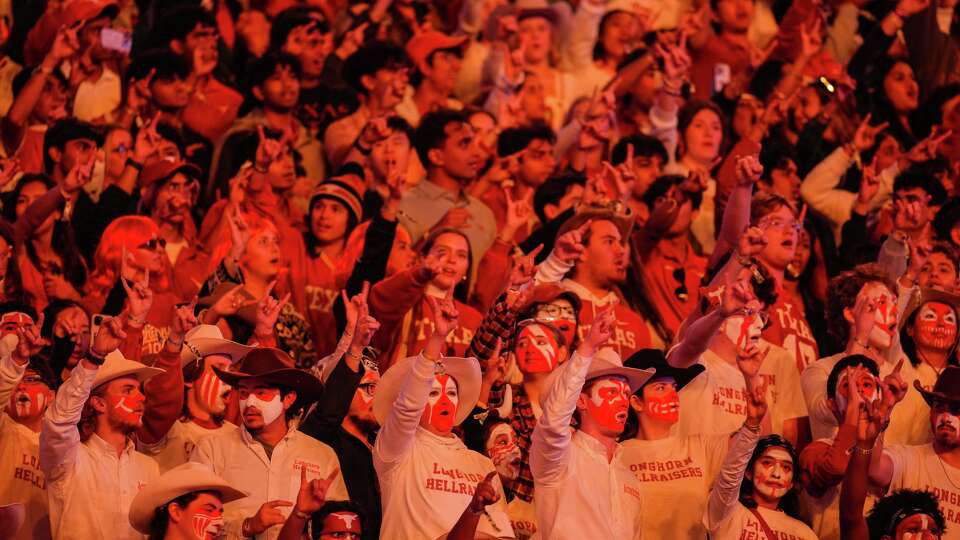 University of Texans fans cheer during the first half of an NCAA college football game against Texans A&M in Austin, Friday, Nov. 28, 2025.