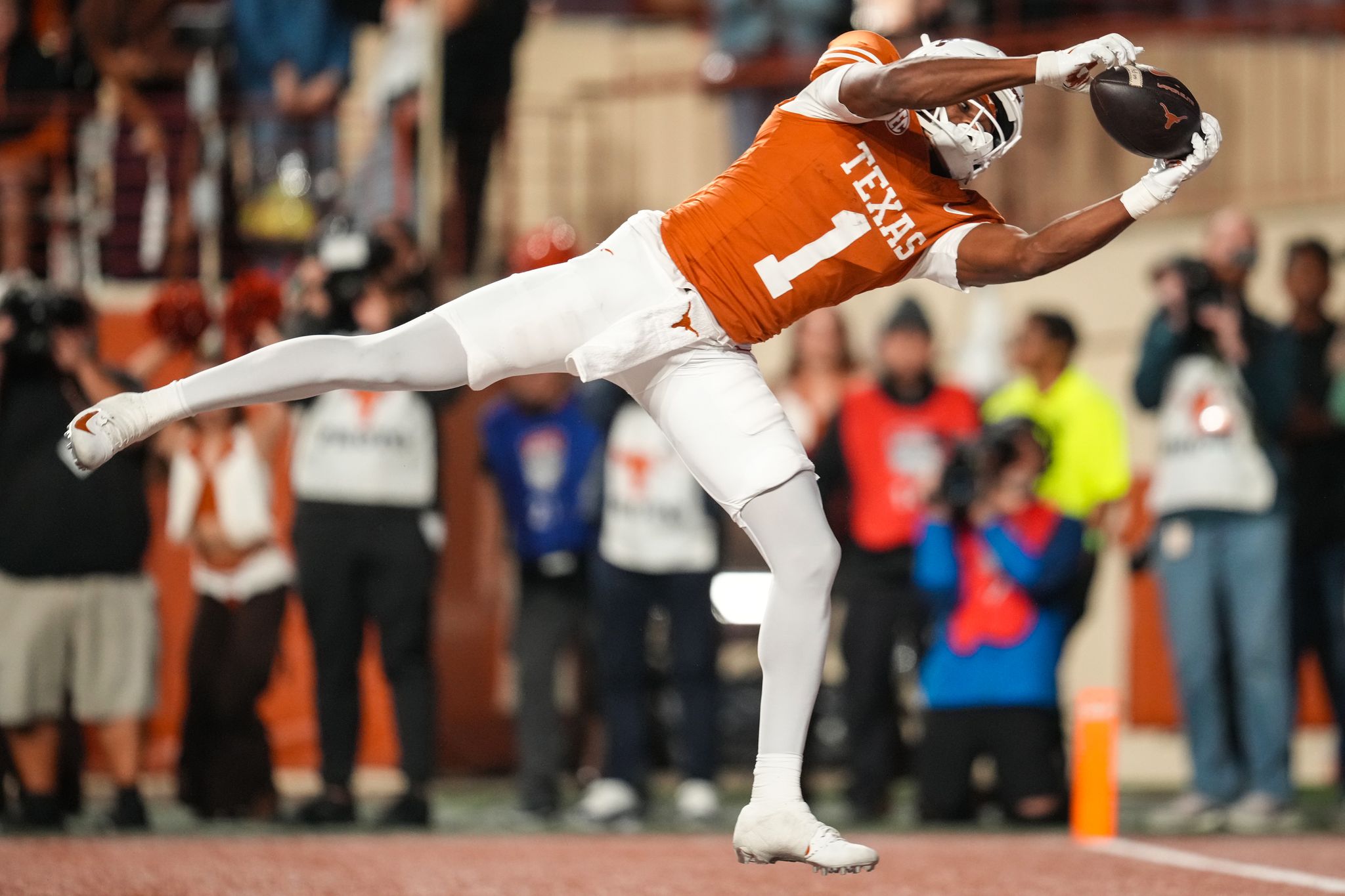 Cam Coleman extends for a football in a Texas Longhorns practice photograph