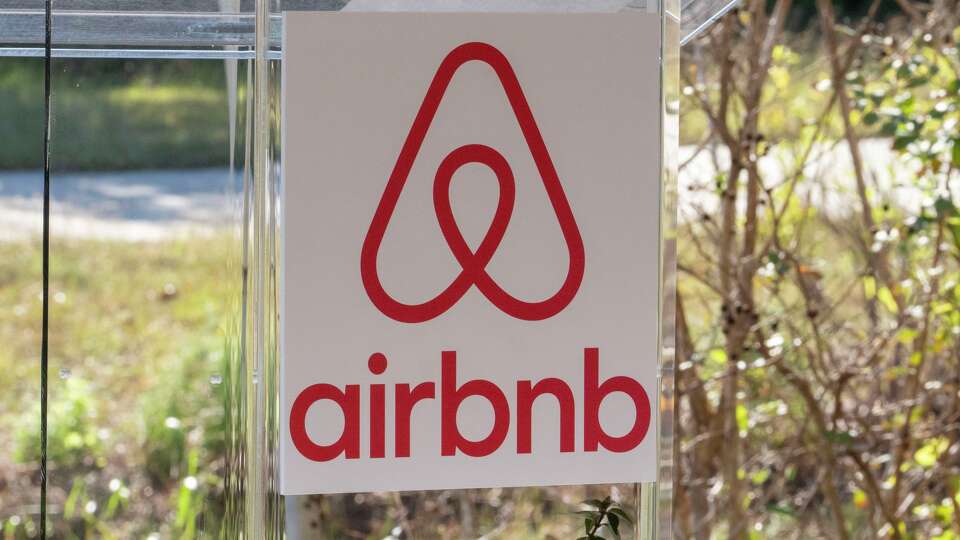 The Airbnb logo is displayed during a press conference in Houston, Tuesday, Dec 2, 2025.