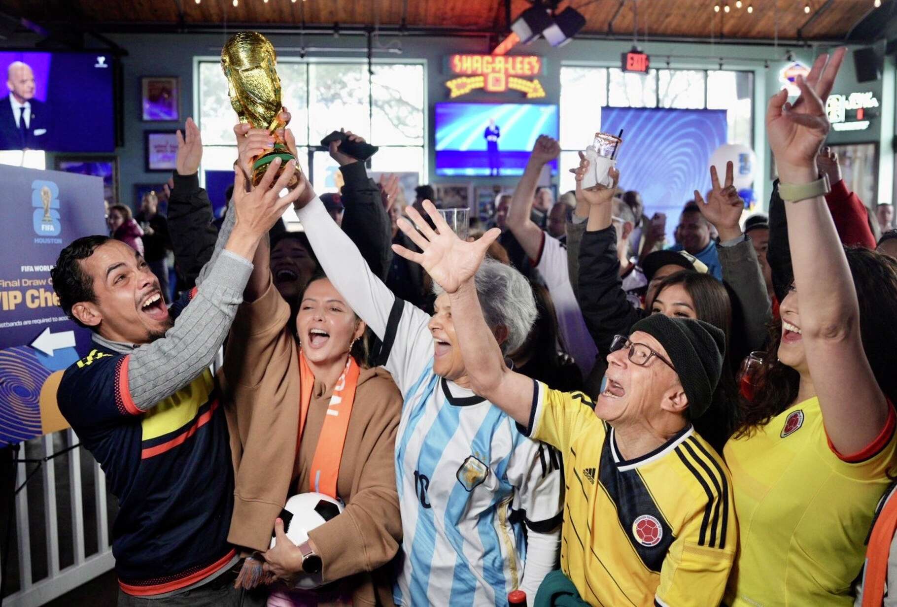 Fans gathered at Little Woodrow's EaDo celebrate during the Houston World Cup host committee's official 2026 FIFA World Cup draw watch party in Houston, Friday, Dec. 5, 2025.