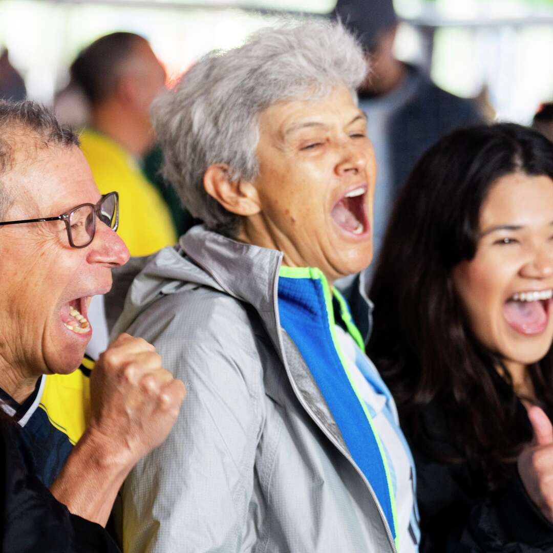 Alfonso Velasquez, left, cheers alongside Gladys Torres and Rebeca Castro as the teams in Groups E, F, H, and K are announced as part of the 2026 FIFA World Cup draw in Houston, Friday, Dec. 5, 2025.