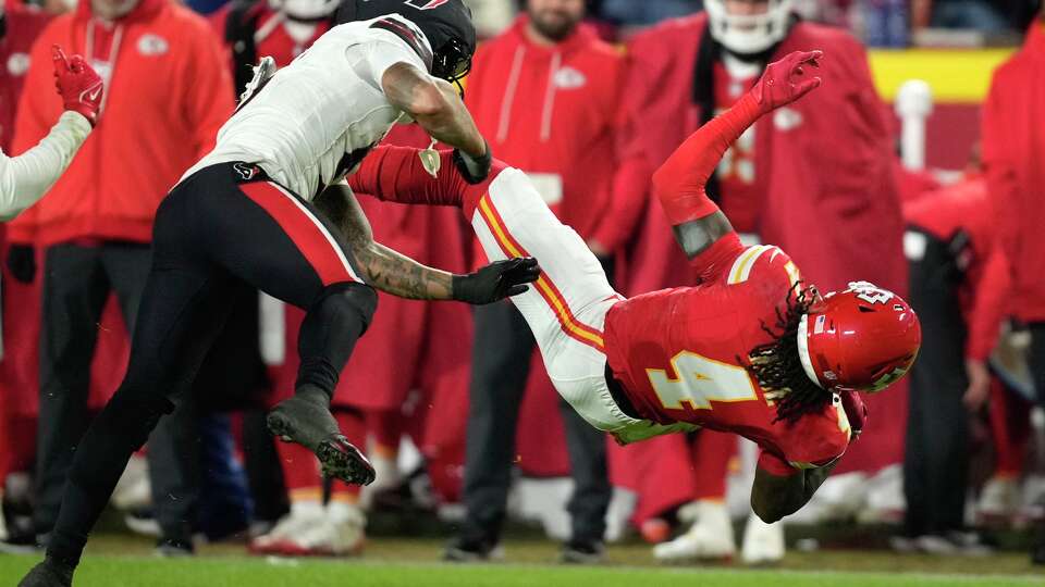 Houston Texans safety Jalen Pitre (5) hits Kansas City Chiefs wide receiver Rashee Rice (4) during the second half an NFL football game in Kansas City, Mo., Sunday, Dec. 7, 2025.
