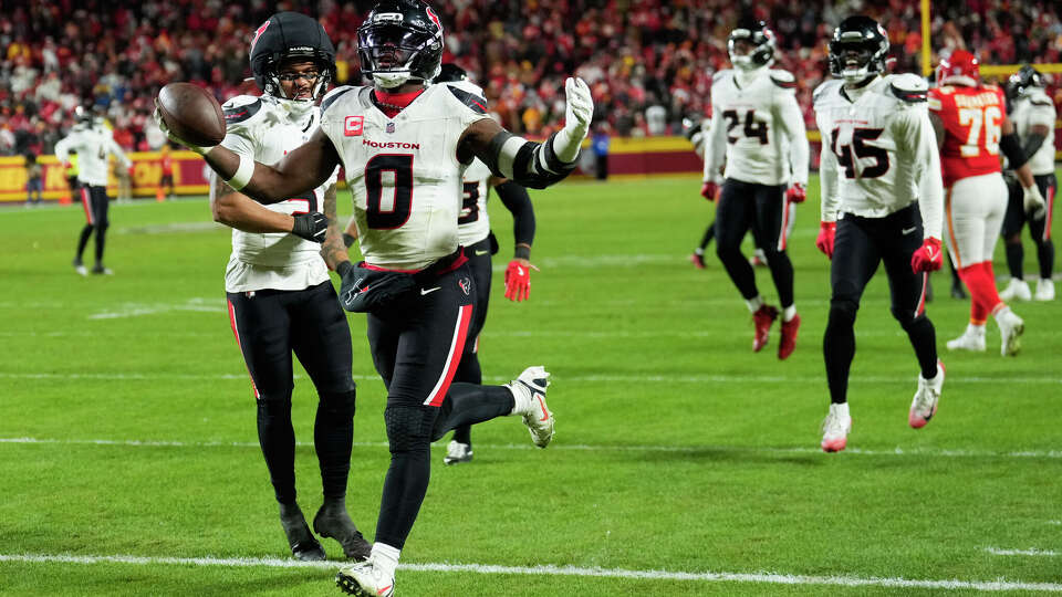Houston Texans linebacker Azeez al-Shaair (0) returns the football after intercepting a pass intended for Kansas City Chiefs tight end Travis Kelce during the second half an NFL football game in Kansas City, Mo., Sunday, Dec. 7, 2025.