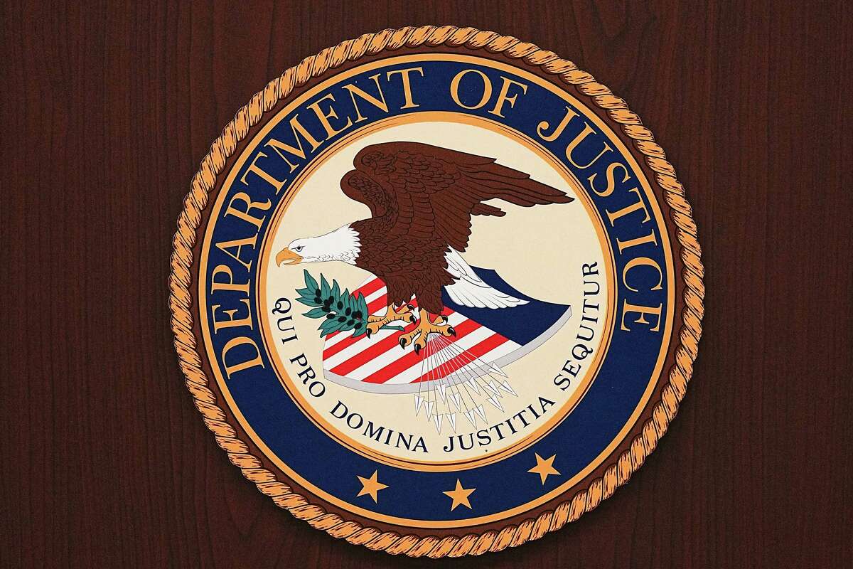 The seal on a podium for the Department of Justice at the U.S. Attorney's Office in Houston on Monday, Dec. 8, 2025.