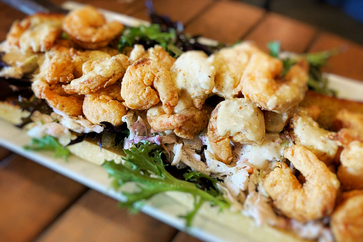 A stock photograph of a shrimp po' boy (also known as a po-boy or poboy), a sandwich originating in Louisiana, with fried breaded shrimp served on French bread.