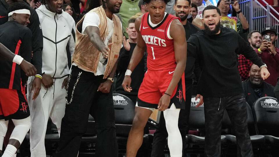 Houston Rockets bench celebrate Houston Rockets guard Amen Thompson (1) tap in to keep the Rockets on top in the fourth quarter against the LA Clippers at the Toyota Center in Houston on Thursday, Dec. 11, 2025. Houston Rockets won the game 115-113.