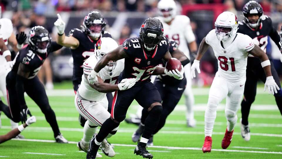 Houston Texans' Dare Ogunbowale returns the football after recovering a fumble forced by linebacker Jamal Hill against Arizona Cardinals wide receiver Jalen Brooks during the first half of an NFL football game at NRG Stadium in Houston, Sunday, Dec. 14, 2025.