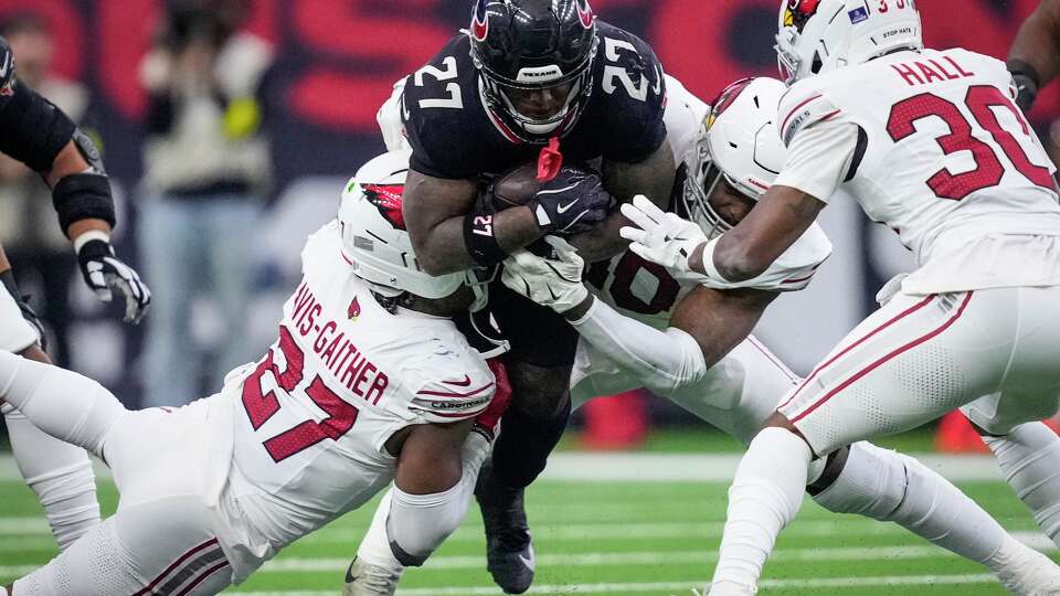 Houston Texans running back Woody Marks (27) is brought down by Arizona Cardinals linebacker Akeem Davis-Gaither (27) during the first half of an NFL football game at NRG Stadium in Houston, Sunday, Dec. 14, 2025.