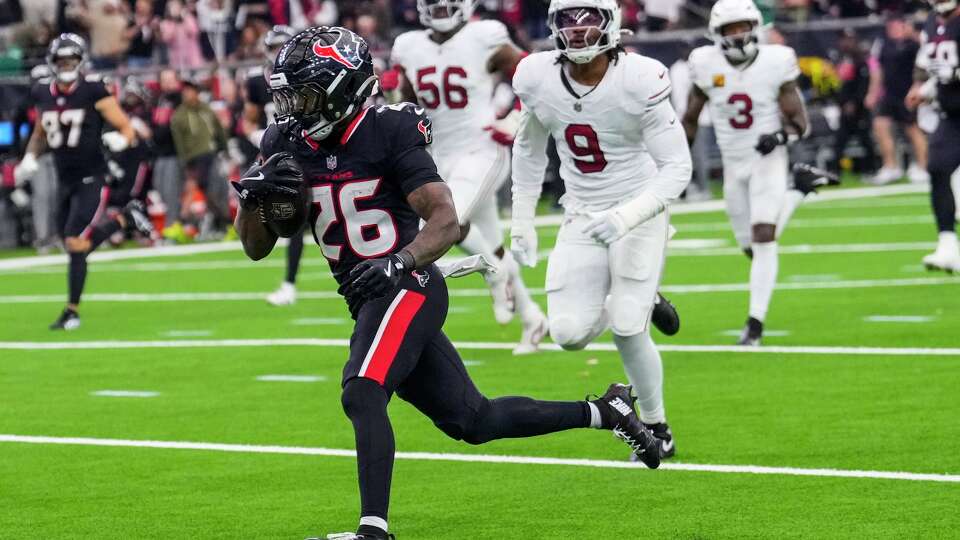 Houston Texans running back Jawhar Jordan (26) breaks past Arizona Cardinals linebacker BJ Ojulari (9) during the second half of an NFL football game at NRG Stadium in Houston, Sunday, Dec. 14, 2025.