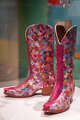 Python-patterned cowboy boots made of multicolored paillettes are seen on display in the “Particles of Color: Where Science Meets Fashion” exhibit at the Texas Science and Natural History Museum in Austin, Thursday, Dec. 11, 2025.