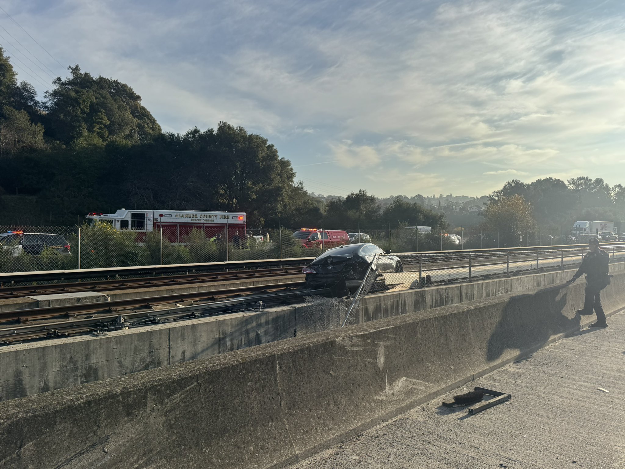 BART service halted after car from freeway crash falls onto the tracks