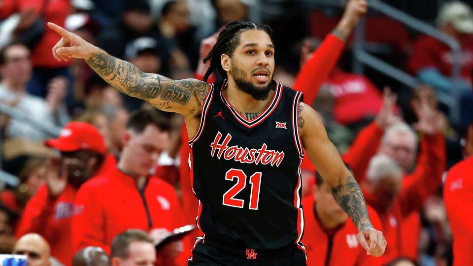 Houston guard Emanuel Sharp reacts after making a three-point shot against Arkansas during the second half of an NCAA college basketball game, Saturday, Dec. 20, 2025, in Newark, N.J. (AP Photo/Noah K. Murray)