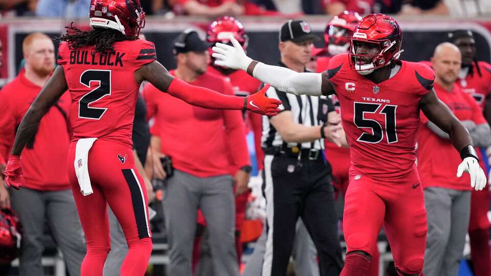 Houston Texans safety Calen Bullock (2) and Houston Texans defensive end Will Anderson Jr. (51) high five after Bullock made a stop on the Las Vegas Raiders during the first half of an NFL football game at NRG Stadium in Houston, Sunday, Dec. 21, 2025.