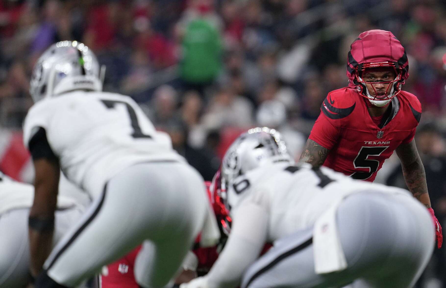 Houston Texans safety Jalen Pitre (5) keeps an eye on Las Vegas Raiders quarterback Geno Smith (7) at NRG in Houston on Sunday, Dec. 21, 2025. Houston Texans won the game 23-21.