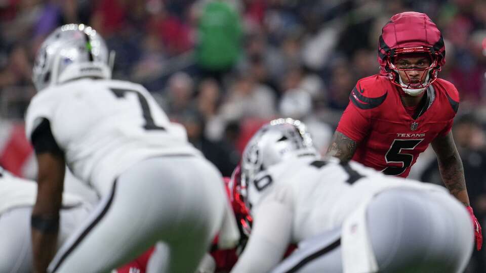 Houston Texans safety Jalen Pitre (5) keeps an eye on Las Vegas Raiders quarterback Geno Smith (7) at NRG in Houston on Sunday, Dec. 21, 2025. Houston Texans won the game 23-21.