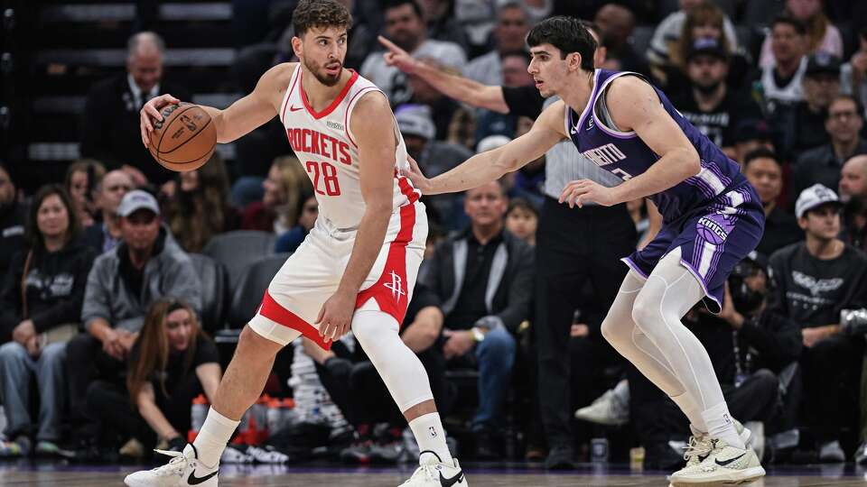 Houston Rockets center Alperen Sengun (28) dribbles against Sacramento Kings center Maxime Raynaud, right, during the first half an NBA basketball game, Sunday, Dec. 21, 2025, in Sacramento, Calif. (AP Photo/Justine Willard)