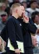 San Antonio Spurs head coach Mitch Johnson, back, talks to associate head coach Sean Sweeney as their team takes on the Oklahoma City Thunder at Frost Bank Center in San Antonio, Tuesday, Dec. 23, 2025. The Spurs defeated the Thunder, 130-110.