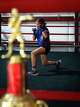 Lily Hernandez, 11, warms up for practice at Let ‘Em Fly Boxing in Kyle, Texas, Dec. 19, 2025 as an Outstanding Club trophy from the junior olympics is displayed ahead of the gym’s holiday party. Lily, the daughter of gym founder and coach Fabian Hernandez, is a nationally-ranked athlete and a huge part of the gym’s growing competitive success, along with her older brother, Jayden, 15.