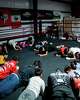 Athletes condition with a core workout during practice ahead of the annual holiday party at Let ‘Em Fly Boxing in Kyle, Texas, Dec. 19, 2025.