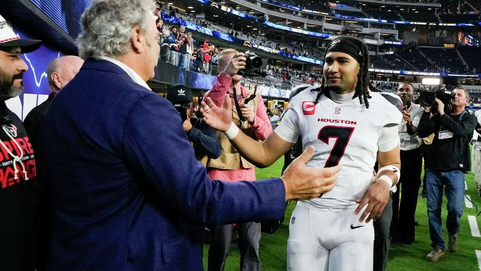 Houston Texans quarterback C.J. Stroud, right, gets a high-five from Texans owner Cal McNair following the team’s 20-16 win over the Los Angeles Chargers after an NFL football game in Inglewood, Calif., Saturday, Dec. 27, 2025.