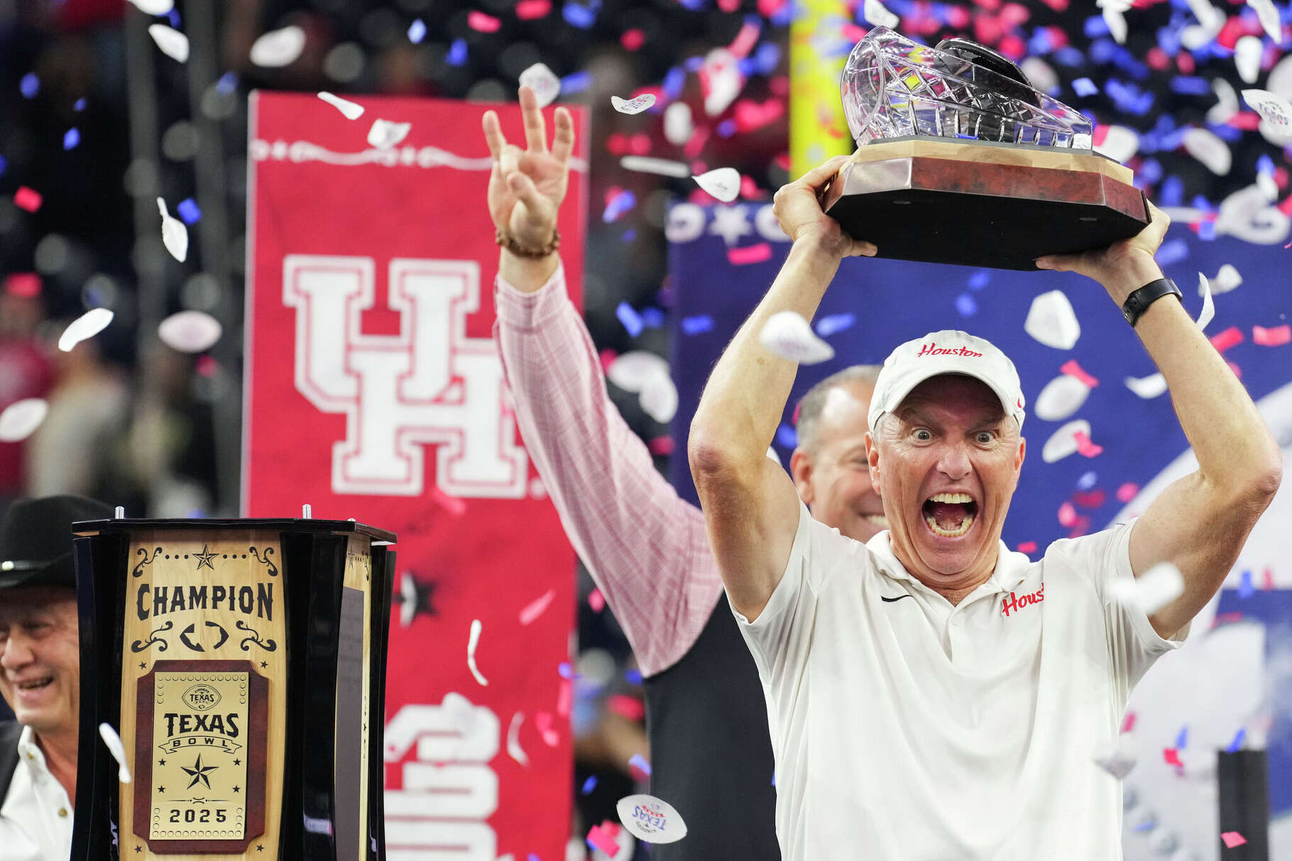 Houston head coach Willie Fritz reacts as he holds up the Texas Bowl trophy after defeating LSU 38-35 during the Kinder’s Texas Bowl in Houston, Sunday, Dec. 28, 2025.