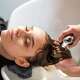Young women customer washing her hair by beautician after dye hair at beauty salon. Beauty Salon business.