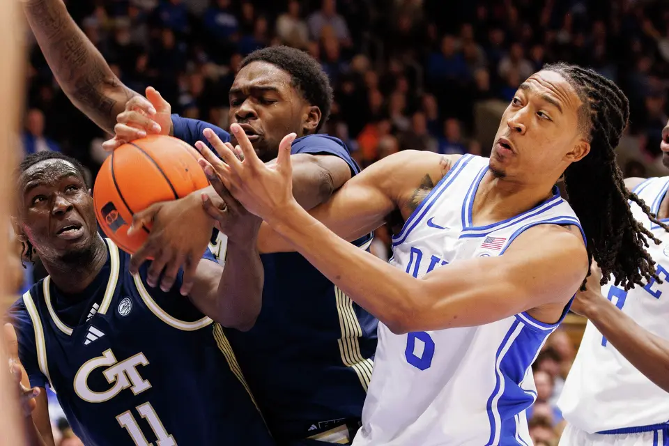 Duke's Maliq Brown, right, battles for a rebound with Georgia Tech's Baye Ndongo (11) and Peyton Marshall, middle, during the first half of an NCAA college basketball game in Durham, N.C., Wednesday, Dec. 31, 2025.