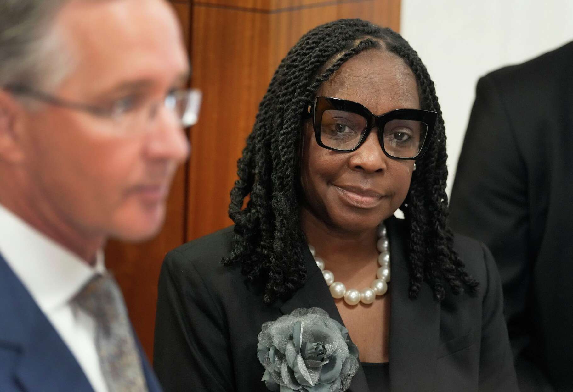 Carla Wyatt, Harris County treasurer, right, is shown as her attorney Christopher Downey speaks to the media after a court appearance on her misdemeanor burglary charge in Houston Friday, Jan. 2, 2026. She is accused of breaking into another person’s vehicle with intent to commit theft.