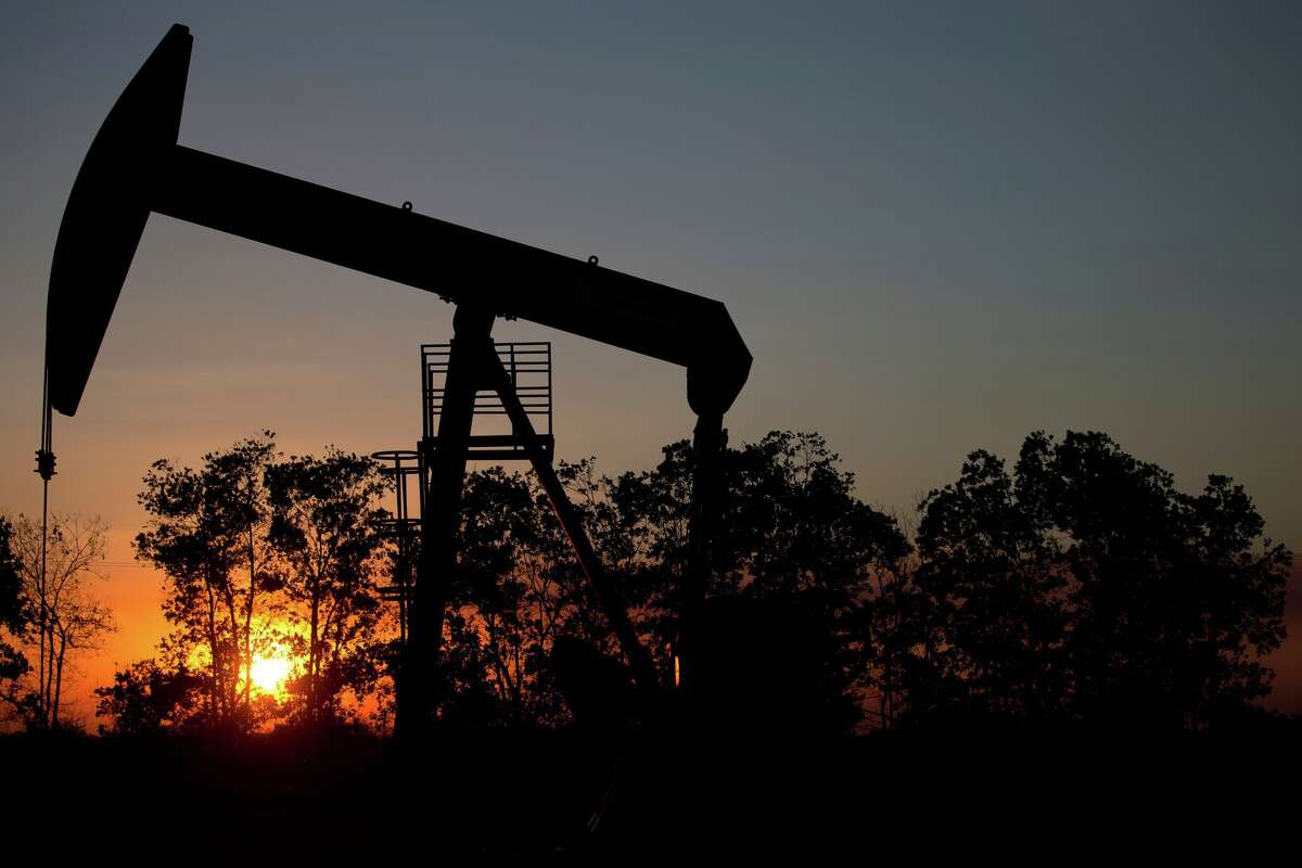 In this Feb. 19, 2015 photo, the sun sets behind an oil well in a field near El Tigre, a town within Venezuela's Hugo Chavez oil belt, formally known as the Orinoco Belt. President Nicolas Maduro, whose approval rating has plunged to around 25 percent, has no choice but to lean on state-fun oil company PDVSA to help Venezuela back on its feet and has been quietly trying to lure back foreign drillers. (AP Photo/Fernando Llano)