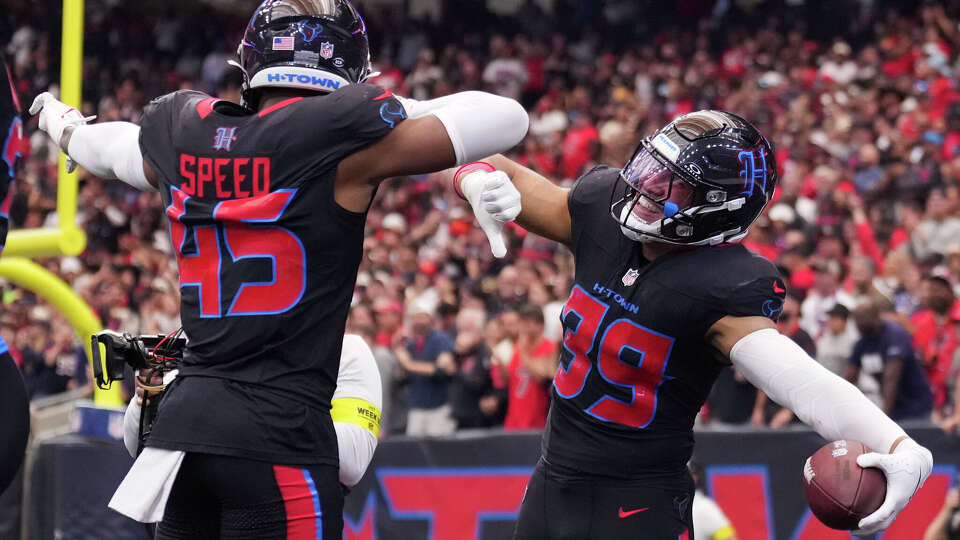 Houston Texans linebacker Henry To'oto’o, right, celebrates with linebacker E.J. Speed after recovering a fumble by Indianapolis Colts quarterback Riley Leonard.