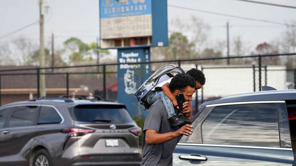 Students are picked up at the end of the school day at HISD's Law Elementary School in Houston, Tuesday, Jan. 6, 2026.