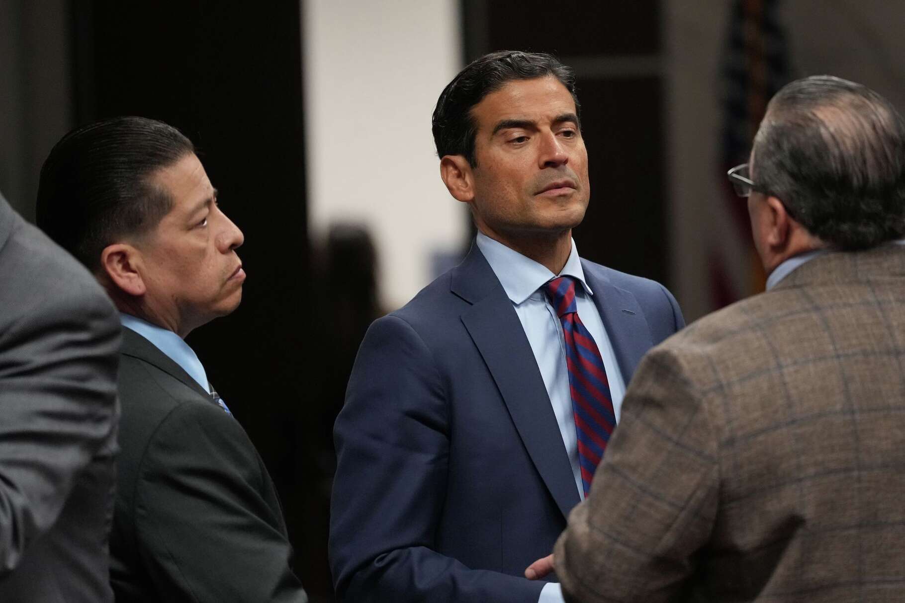 Former Uvalde school district police officer Adrian Gonzales, left, stands with his attorney Nico LaHood during a break in his trial at the Nueces County Courthouse in Corpus Christi, Texas, Tuesday, Jan. 6, 2026.