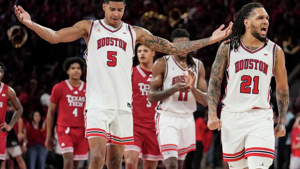 Houston center Chris Cenac Jr. (5) and guard Emanuel Sharp (21) react as the Cougars took a late lead against Texas Tech in the second half of an NCAA college basketball game at Fertitta Center in Houston, Tuesday, Jan. 6, 2026.