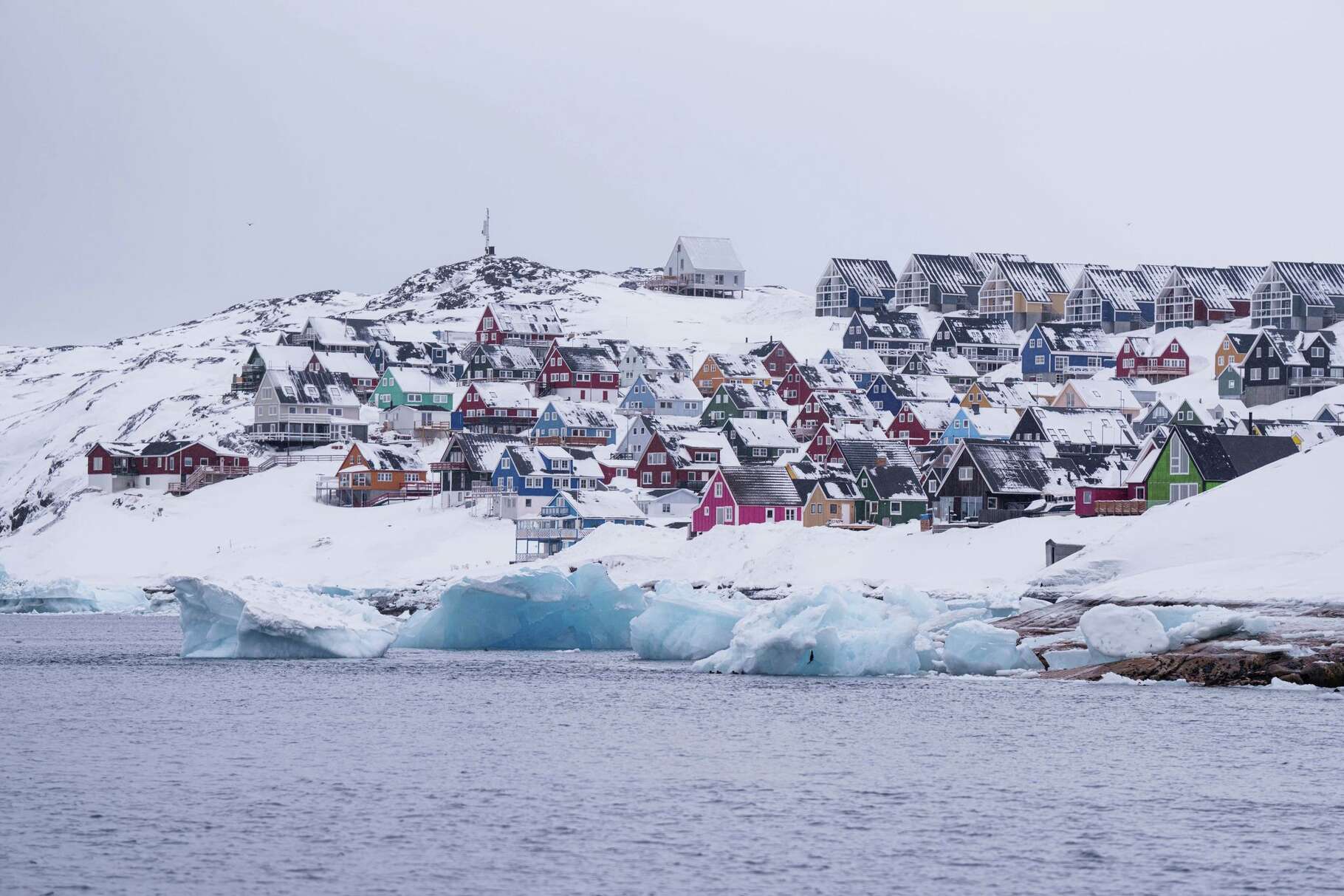 FILE - Coloured houses covered by snow are seen from the sea in Nuuk, Greenland, on March 6, 2025.