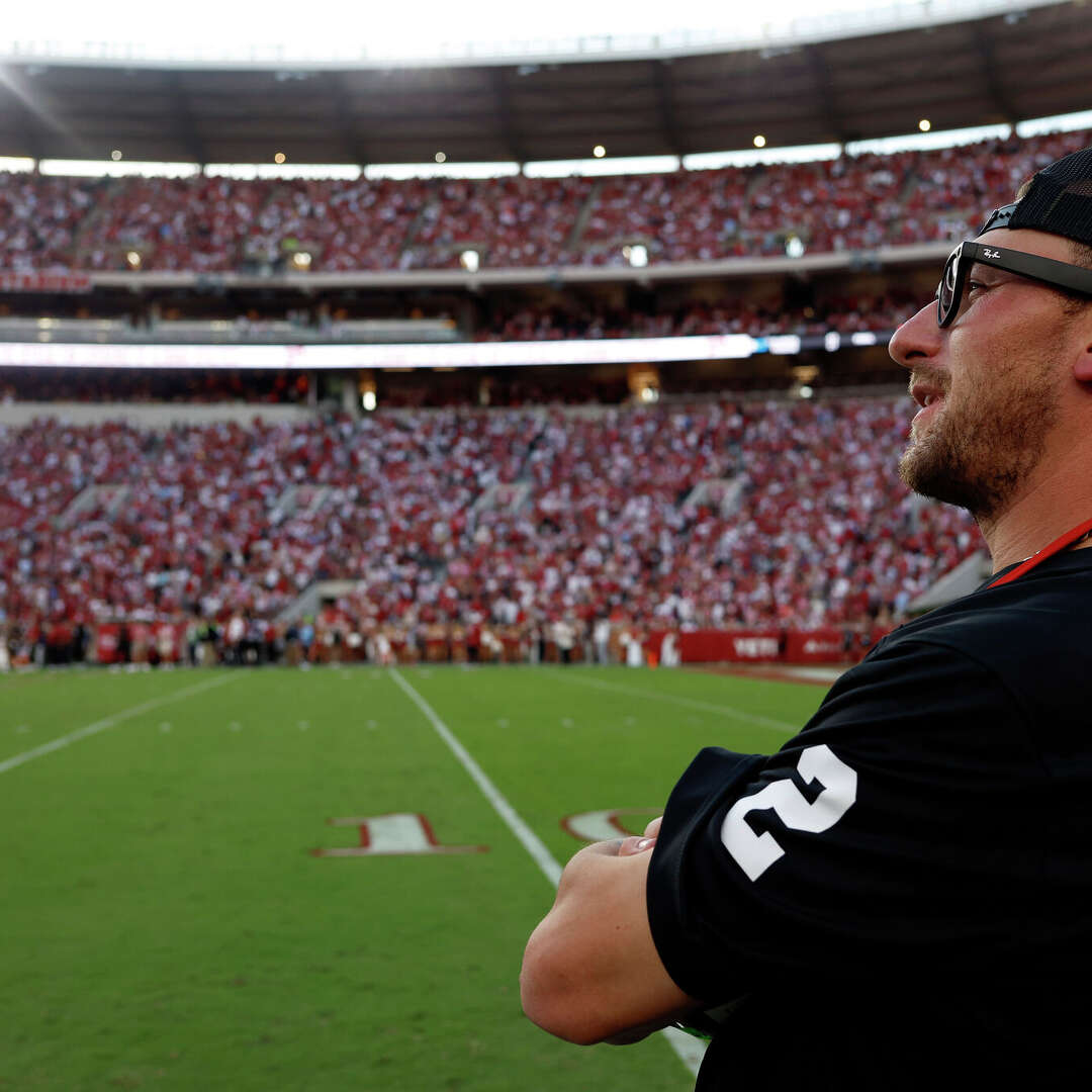Texas A&M Heisman Trophy winner Johnny Manziel watches the fourth quarter of the game between the Alabama Crimson Tide and the Vanderbilt Commodores at Bryant-Denny Stadium on October 4, 2025 in Tuscaloosa, Alabama.