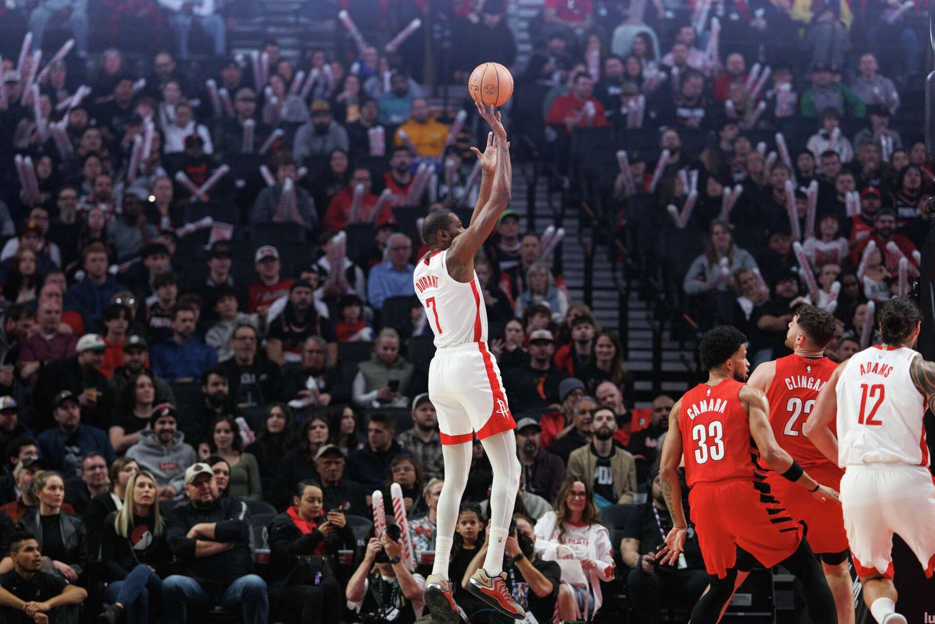 Houston Rockets forward Kevin Durant, center, shoots against the Portland Trail Blazers during the first half of an NBA basketball game Friday, Jan. 9, 2026, in Portland, Ore. (AP Photo/Howard Lao)