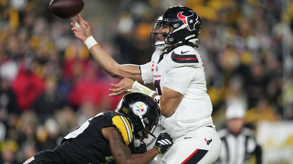 Houston Texans quarterback C.J. Stroud (7) is hit by Pittsburgh Steelers cornerback Brandin Echols (26) as he throws after picking up a fumble during the first half of an NFL wild-card playoff football game in Pittsburgh, Monday, Jan. 12, 2026.