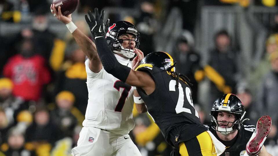 Houston Texans quarterback C.J. Stroud (7) is pressured by Pittsburgh Steelers safety Kyle Dugger (29) during the first half of an NFL wild-card playoff football game in Pittsburgh, Monday, Jan. 12, 2026.
