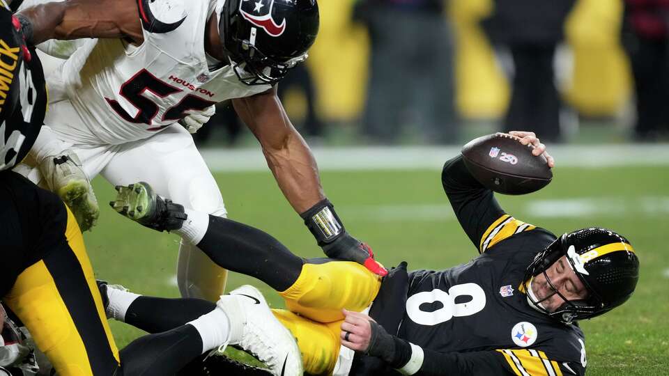 Pittsburgh Steelers quarterback Aaron Rodgers (8) reacts after being sacked by Houston Texans defensive end Danielle Hunter (55) during the first half of an NFL wild-card playoff football game in Pittsburgh, Monday, Jan. 12, 2026.