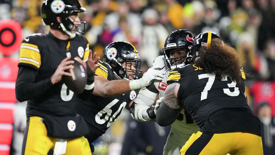 Houston Texans defensive end Will Anderson Jr. (51) is double-teamed by Pittsburgh Steelers offensive tackle Dylan Cook (60) and guard Isaac Seumalo (73) while attempting to pressure quarterback Aaron Rodgers during the second half of an NFL wild-card playoff football game in Pittsburgh, Monday, Jan. 12, 2026.