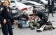 Law enforcement hovers over the shooter in a parking lot after he fired shots Monday morning, June 17, 2019 at the Earle Cabell federal courthouse in downtown Dallas. Law enforcement returned fire and the shooter was hit by gunfire. No officers or citizens were injured. (Tom Fox/The Dallas Morning News)