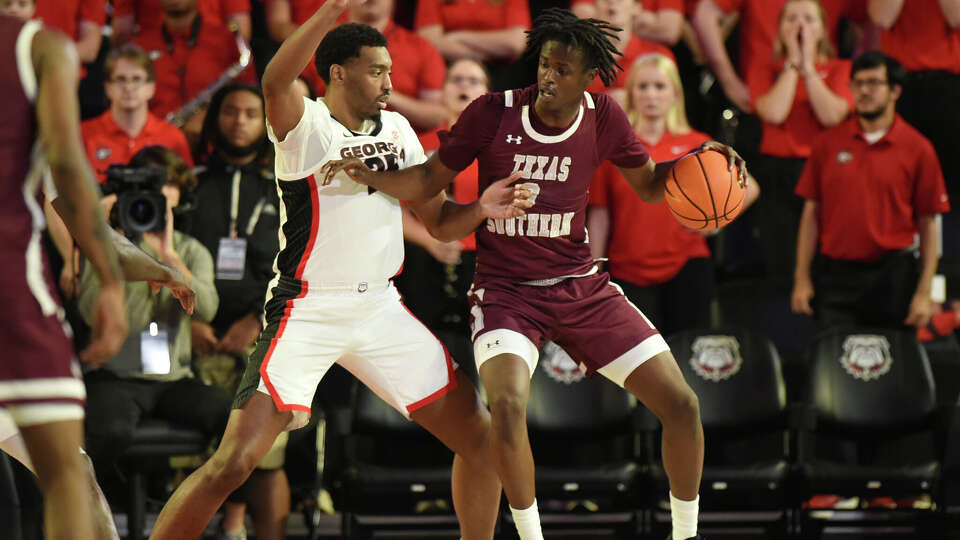 Texas Southern Tigers forward Oumar Koureissi (3) drives to the basket as Georgia Bulldogs forward Justin Abson (25) defends during the college basketball game between the Texas Southern Tigers and the Georgia Bulldogs on November 10, 2024, at Stegeman Coliseum in Athens, GA.